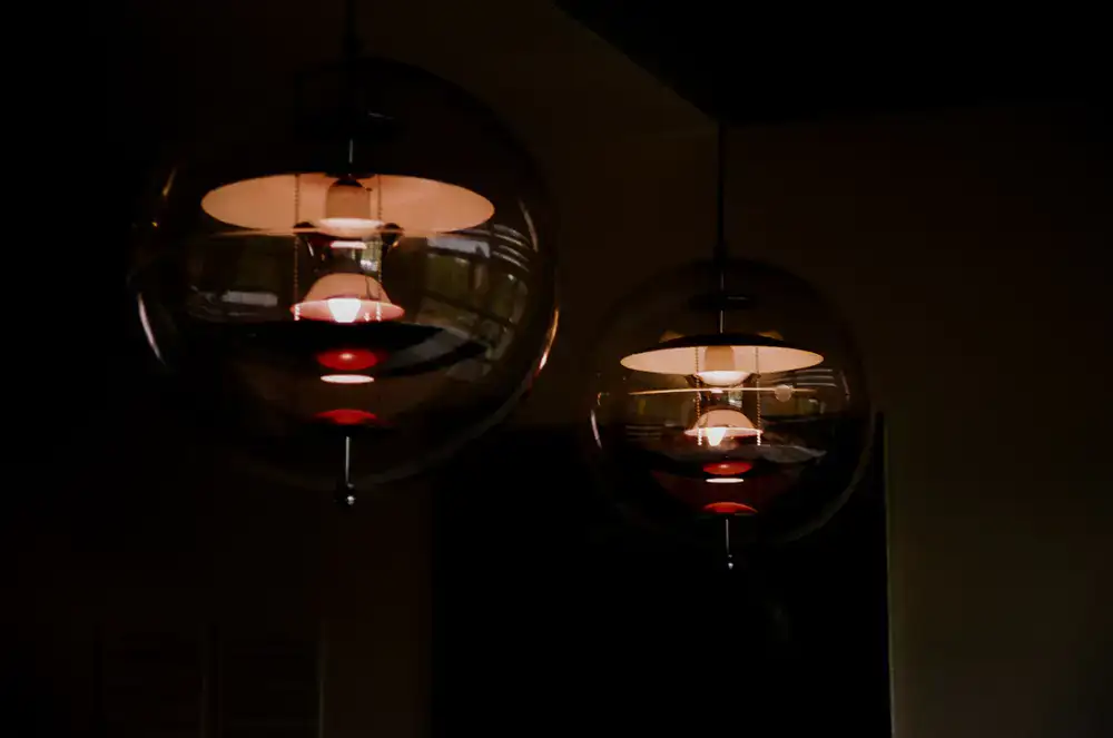 Custom blown glass pendant lighting fixture hanging in a dining space