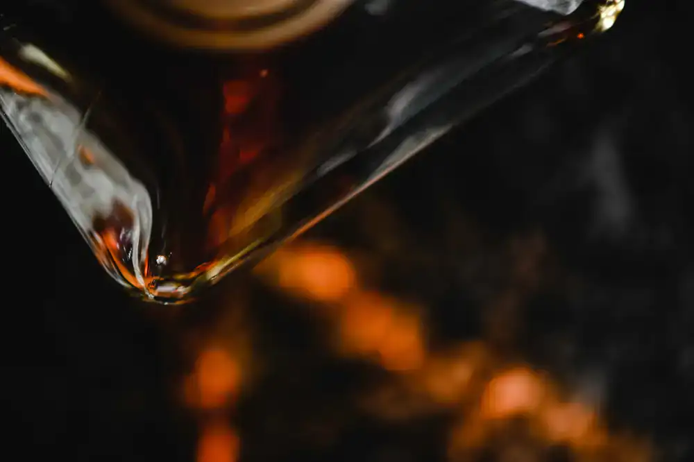 Close-up of a clear and amber glass sculpture